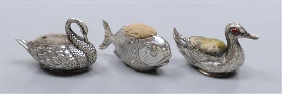 Three assorted novelty silver pin cushions,